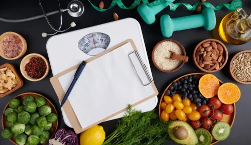 Weight loss scale with centimeter, stethoscope, dumbbell, clipboard, pen. diet concept.